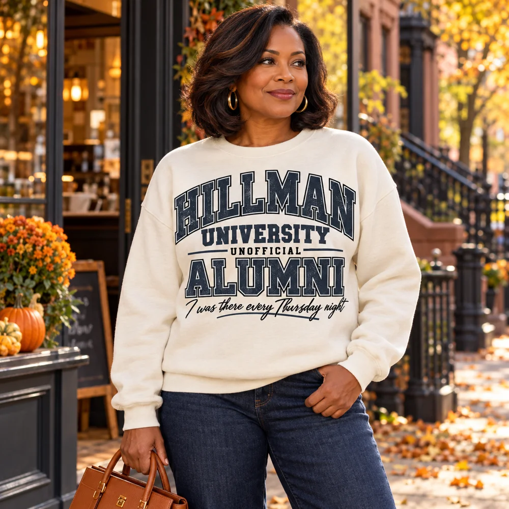 Hillman University Unofficial Alumni charcoal navy design on a cream sweatshirt, fall street